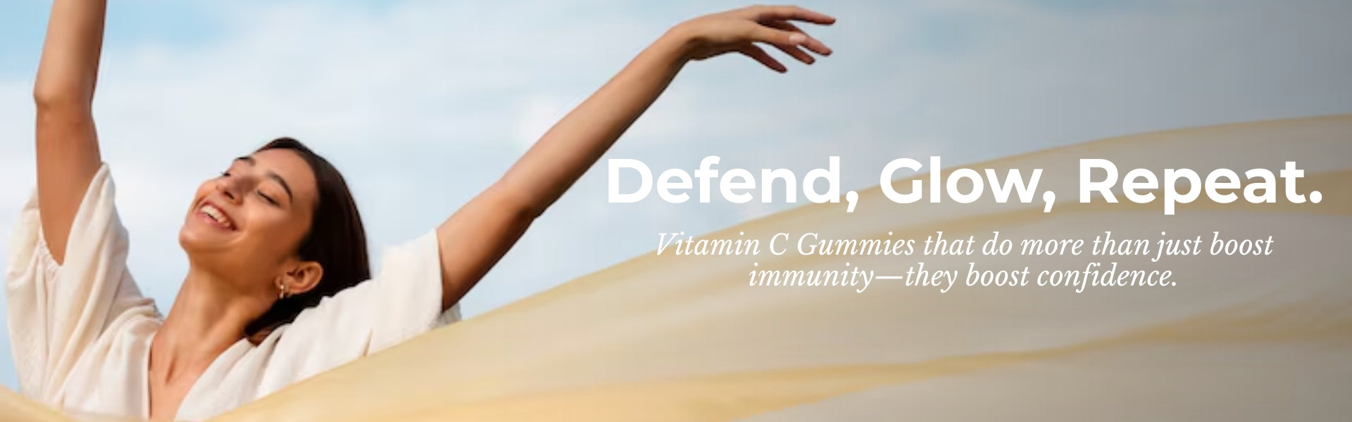 Woman with arms raised against a blue sky, promoting Vitamin C gummies with text overlay.