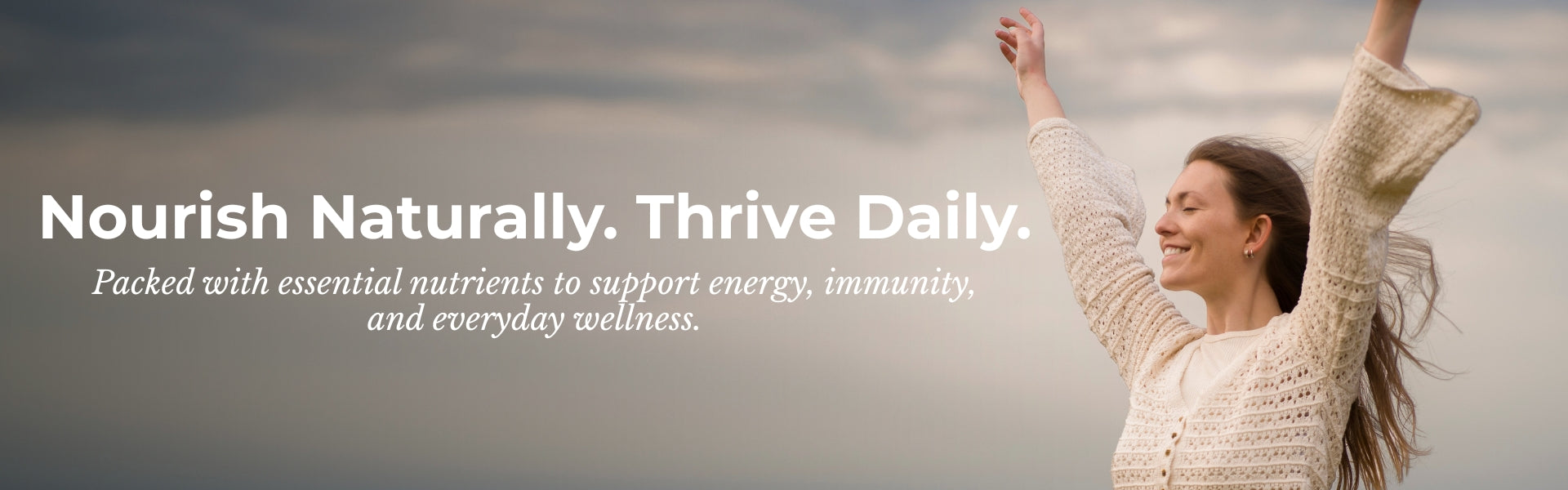 Woman in a cream sweater with arms raised against a cloudy sky, with text about natural nutrition and wellness.