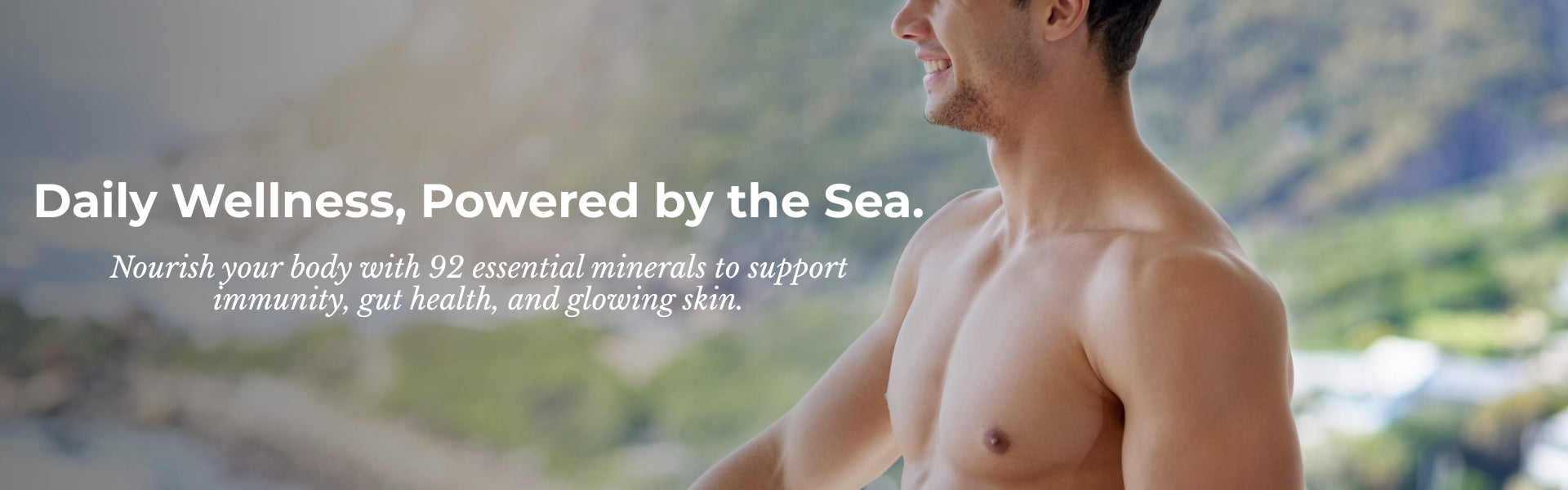 Man standing by a body of water with text about daily wellness powered by the sea.