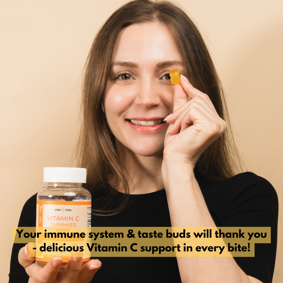 Woman holding Vitamin C supplements on beige | Herb Terra