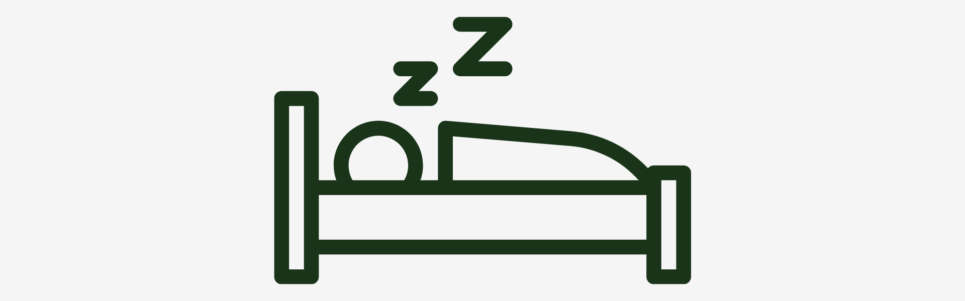 Green icon of a person sleeping on a bed with 'z' symbols above, on a white background.